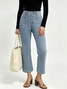 Detail view of high-waisted light blue denim jeans with a four-button fly and straight-leg fit