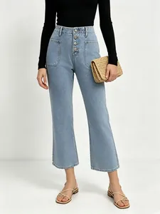 Detail of light blue high-waisted jeans featuring four metal buttons and large pockets
