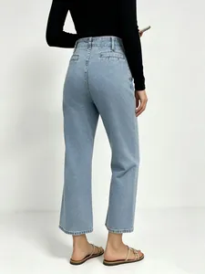Rear view of high-waisted wide-leg denim pants in vintage light blue wash and clean design