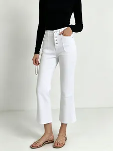 Detail of high-waisted white jeans featuring five-button fly and large patch pockets