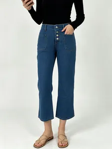 Detailed view of high-waisted denim jeans featuring a four-button front closure design