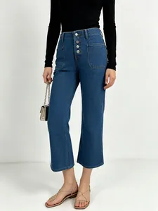 Detail view of high waist denim jeans featuring a four-button fly and front patch pockets