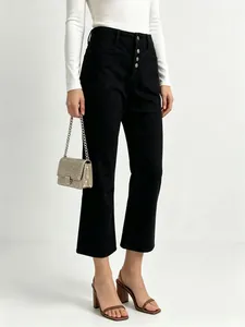 Close-up of high-waist black wide-leg jeans featuring a stylish multi-button fly detail