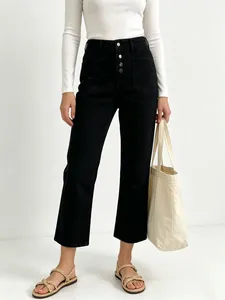 Detail of high-waist black wide-leg trousers featuring a unique four-button front fly
