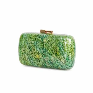 Detail of green marble acrylic evening clutch with luxury gold metal clasp closure