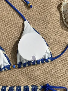 Detail of blue striped crochet bikini top featuring removable pads and beaded straps