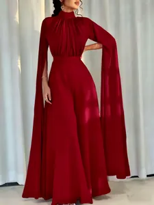 Detail of high neck pleated collar and flowing cape sleeves on red satin jumpsuit