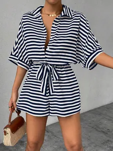 Detail of nautical striped romper with lapel collar, buttons, and matching waist tie