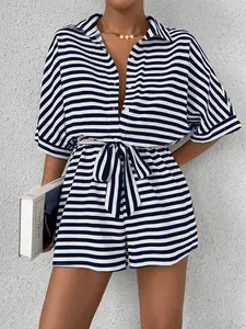 Detail of blue and white striped romper featuring a shirt collar and button-down front