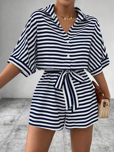 Detail of blue and white striped romper with buttoned collar and waist tie design