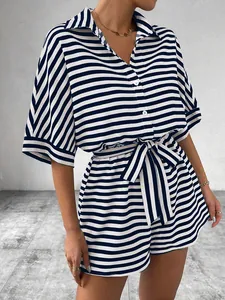 Detail view of blue and white striped shirt with matching drawstring shorts and waist tie