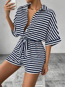 Detail of blue and white striped romper featuring a lapel collar and waist tie belt