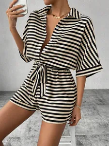 Detail of striped short jumpsuit showing the button-down lapel and tie-waist design