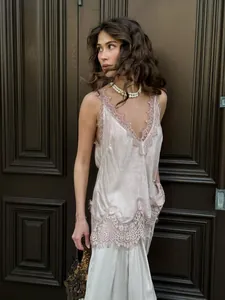 Detailed close-up of champagne velvet camisole with delicate lace trim on V-neckline