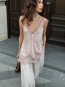 Detail of silk satin camisole featuring delicate lace trim and deep V-neckline finish