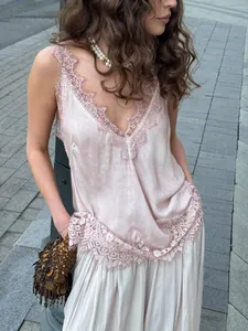 Detail of pink satin camisole featuring delicate eyelash lace trim and V-neckline