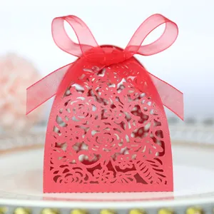 Detailed laser-cut floral patterns on red wedding favor box with a satin ribbon bow