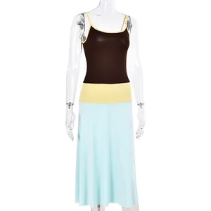 Detail of color-block dress showing brown top, yellow waist, and blue A-line skirt