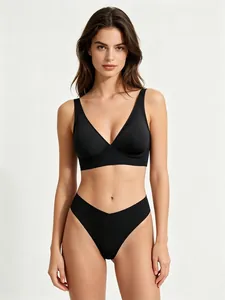 Detail of seamless black V-neck bra and matching thong set in soft touch fabric