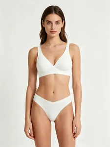Close-up of seamless white wire-free bra and matching high-cut thong on model
