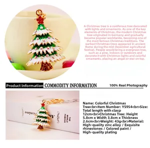 Detail of green enamel Christmas tree keychain with colorful rhinestones and gold plating