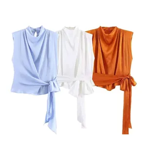 Women's sleeveless high neck draped top with side tie bow in blue, white, and orange