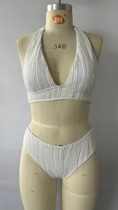 Close-up of white ribbed fabric texture on halter v-neck bikini top with detailed stitching