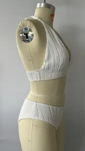 Side view of white halter bikini set with pleated texture on a mannequin