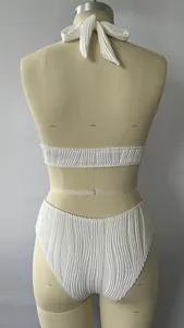 Rear view of white halter bikini showing detailed vertical pleated texture fabric on mannequin