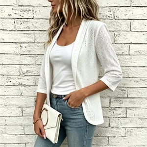Detailed view of white eyelet embroidery and lace texture on a casual cardigan sleeve