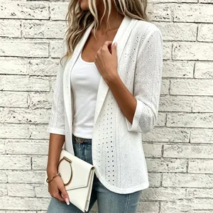 Detail of elegant white hollow-out crochet cardigan with geometric patterns and 3/4 sleeves