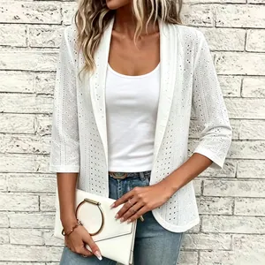Detailed view of the intricate white lace embroidery and hollow eyelet patterns on the cardigan