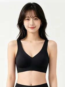 Front view of seamless black V-neck sports bra with wide straps on a fashion model
