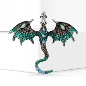 Macro detail of alloy dragon brooch with green enamel wings and colorful rhinestones