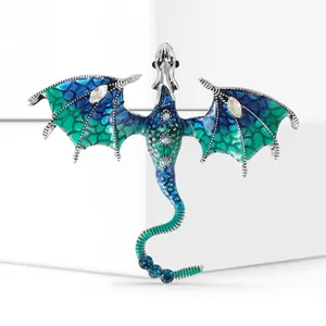 Close-up of blue enamel dragon brooch with crystal details on silver alloy base