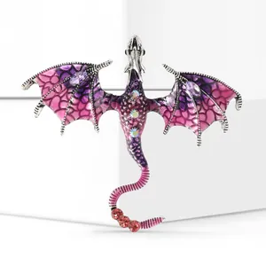 Macro view of pink dragon brooch featuring translucent enamel wings and sparkling rhinestones