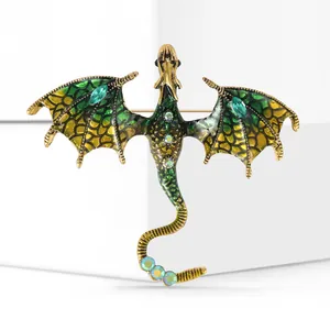 Detail of a flying dragon brooch with green enamel wings and colorful rhinestones