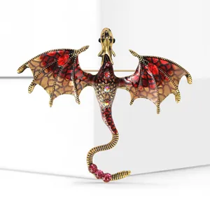 Macro detail of dragon brooch showing red enamel wings and sparkling crystal scales