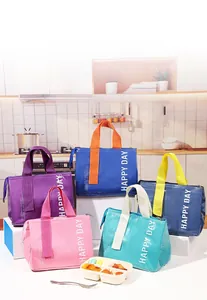 Detailed view of colorful lunch bags with HAPPY DAY text and waterproof coating finish