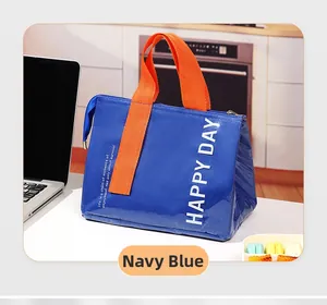 Close-up of navy blue insulated lunch bag with orange handles and Happy Day text