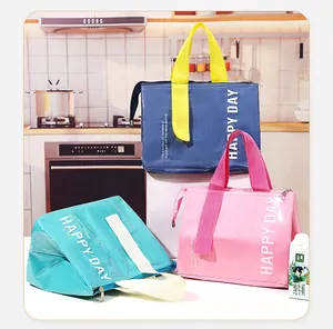 Close-up of portable insulated lunch bags in blue, pink, and green with durable handles