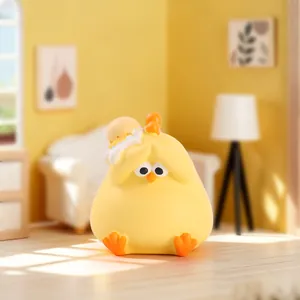 Detailed view of the yellow chick figurine with an eggshell hat in a cozy room setting