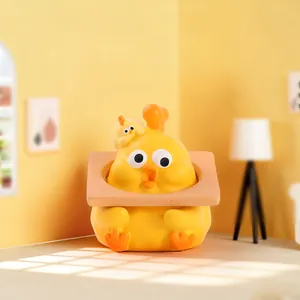 Macro shot of a yellow cartoon chick desktop ornament holding a small frame decor