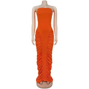 Detail of orange ruched maxi dress showing textured side pleats and slim fit fabric