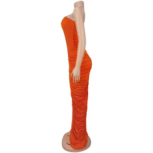 Detail view of the orange ruched fabric texture on a strapless bodycon long dress