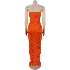 Detail view of the side ruching and back fit of an orange bodycon strapless maxi dress