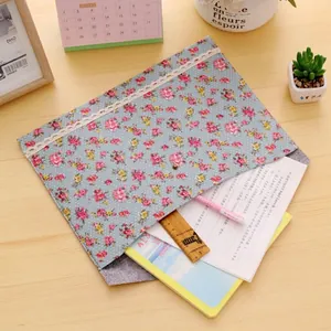 Elegant A4 floral fabric file folder with lace trim and metal button on wood desk
