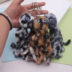 Detailed view of plush octopus keychains featuring leopard prints and large blue eyes