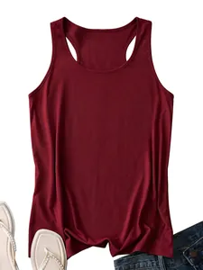 Close-up of deep red racerback tank top paired with denim jeans and pearl sandals