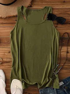 Flat lay of olive green racerback tank top with summer accessories on wood